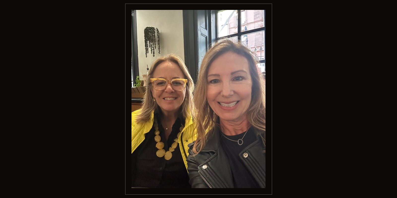 Kathleen Camilli and Susan Pieper together at a table in a New York cafe